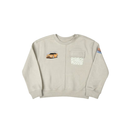 Beige sweatshirt with car graphic and pocket design on a white background