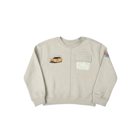 Beige sweatshirt with car graphic and pocket design on a white background