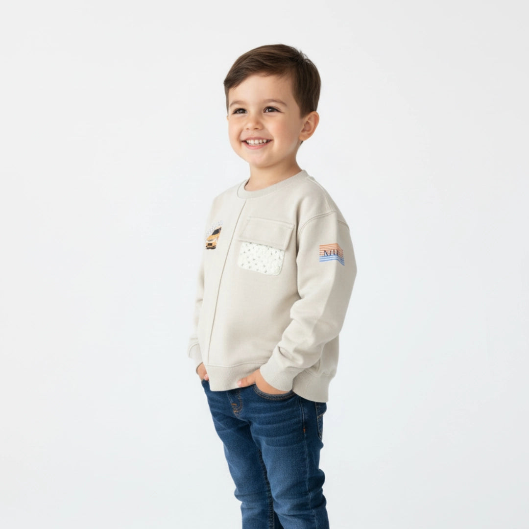Child wearing a beige jacket with patches on a white background
