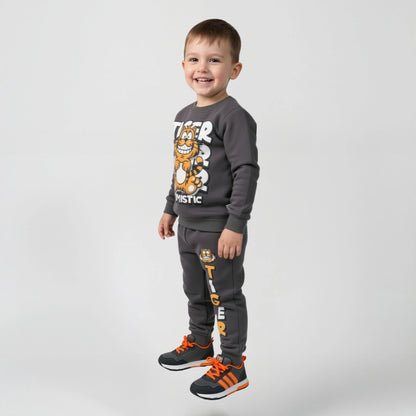 Child wearing a gray tracksuit with cartoon character design on a light gray background