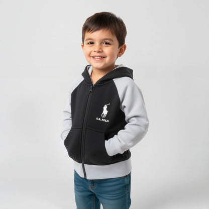 Child wearing a black and gray hoodie with a logo on a light gray background
