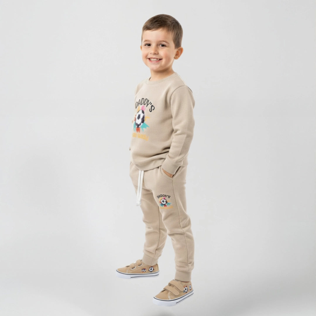 Boy wearing beige fleece two piece set Daddy's written on it with football