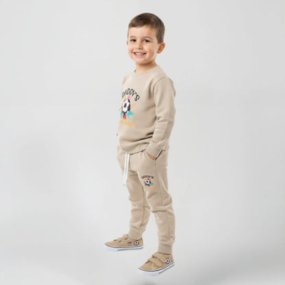 Boy wearing beige fleece two piece set Daddy's written on it with football