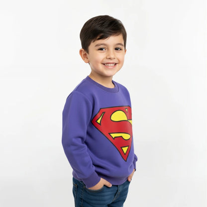Child wearing a blue sweatshirt with a Superman logo on a white background