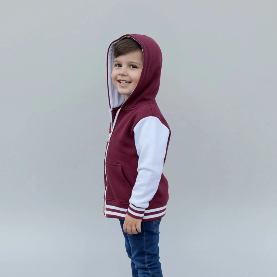 Child wearing a maroon and white hoodie against a plain background