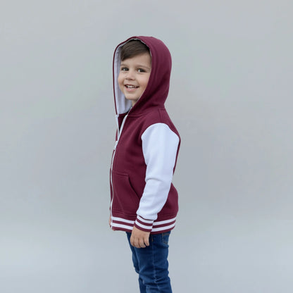 Child wearing a maroon and white hoodie against a plain background